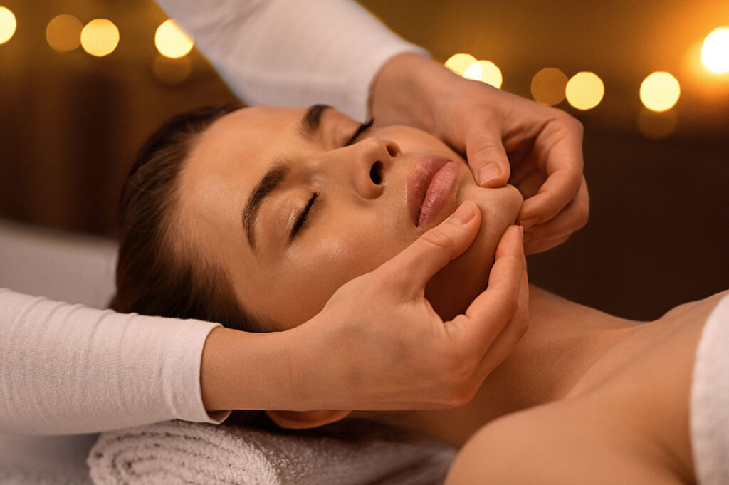 relaxed-woman-getting-healing-face-massage-at-spa-8U8FCM6.jpeg
